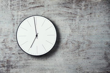 Classic round wall clock on a wooden background with copy space