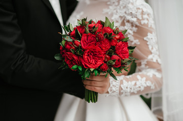 bride holding bouquet of flowers in rustic style, wedding bouquet Groom hugs bride