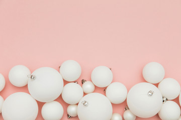 Christmas winter composition. White christmas balls on a pastel pink background