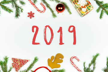 New year flat lay, poster or postcard format. Top view of "2019" letters surrounded by seasonal holiday props and new year decorations