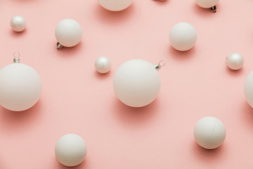 Christmas winter composition. White christmas balls on a pastel pink background