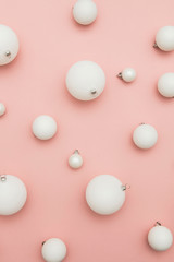 Christmas winter composition. White christmas balls on a pastel pink background