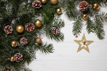 Naklejka na ściany i meble Christmas composition. Christmas tree branches, cones, toys and a golden star on a white background. Made in the style of flatlay.