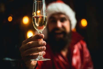 Champagne in hands festive happy men. Santa Claus wishes Merry Christmas and happy new year. Santa is holding champagne in his hands. New year christmas concept.