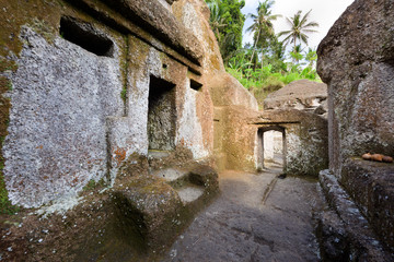 Candi Gunung Kawi hindu temple with niched carved stupas and water stream in Bali, Indonesia.