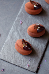 Contemporary Chocolate Violet Mousse Mini Cakes, on dark grey background.

