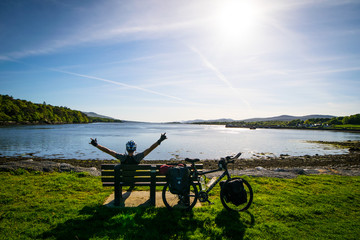 Cyclist enjoy panoramic view break time by the lake