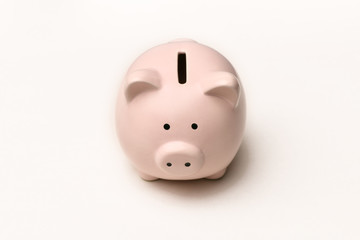 Pink piggy Bank stands on a gray background with a shadow. Horizontal photography