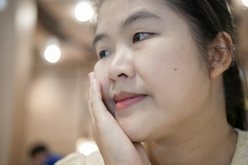 Young Asian Woman Thinking in a coffee shop