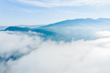 aerial view of clods and fog over mountains hills. magic time