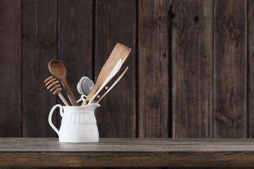 kitchenware on old wooden background