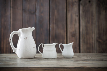 Fototapeta na wymiar white jug on wooden background