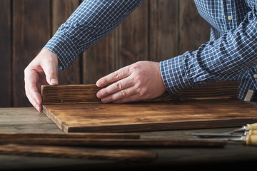 carpenter working with tools on wooden background