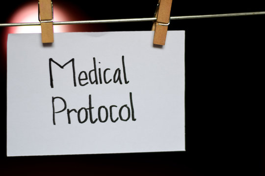 Medical Protocol handwriting on paper. Hanged with a clothes clips, medical and education concept. light blur background