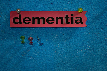 Dementia text on the paper is attached to the styrofoam with push pins, Health care concept as a...