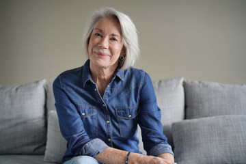  Portrait of modern senior woman in all denim on couch