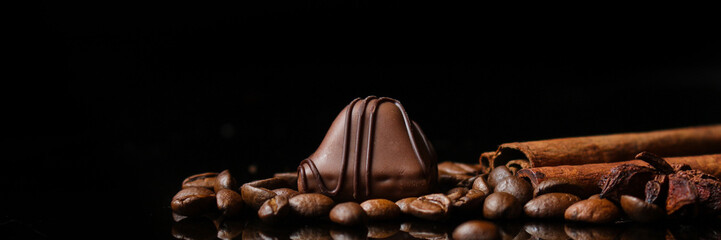 candies, chocolate, filler, cream, coffee (Black background). food background. copy space