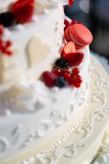 Red decorations on a wedding cake