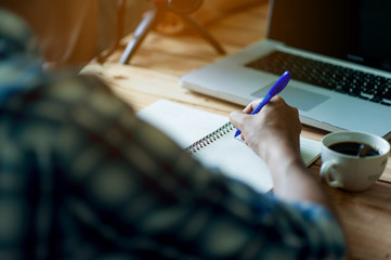 Writing on paper at work on the table in the morning, business ideas. There is space for copying.