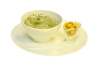 Soup-puree on a platter with crackers on a white background