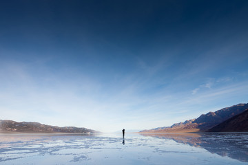 Lone person walking in Badwater, Death Valley