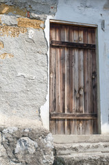 Old wooden door in an old stone house.