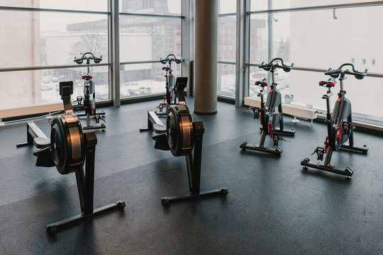 Exercise machines near huge window in gym