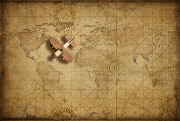 Small wood airplane over world nautical map as travel, explore and communication concept