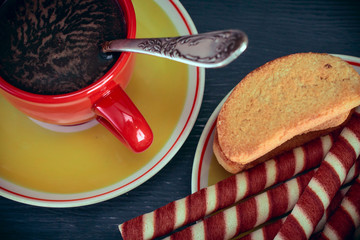 waffle rolls on a plate coffee mug on a dark background