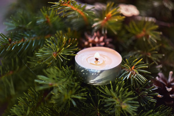 Advent decoration, wreath, candle. In the dark a candle in a beautiful decorative wreath is burning.
