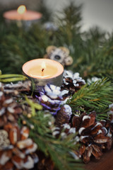 Advent decoration, wreath, candle. In the dark a candle in a beautiful decorative wreath is burning.