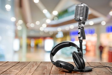 Retro style microphone and headphones on  background
