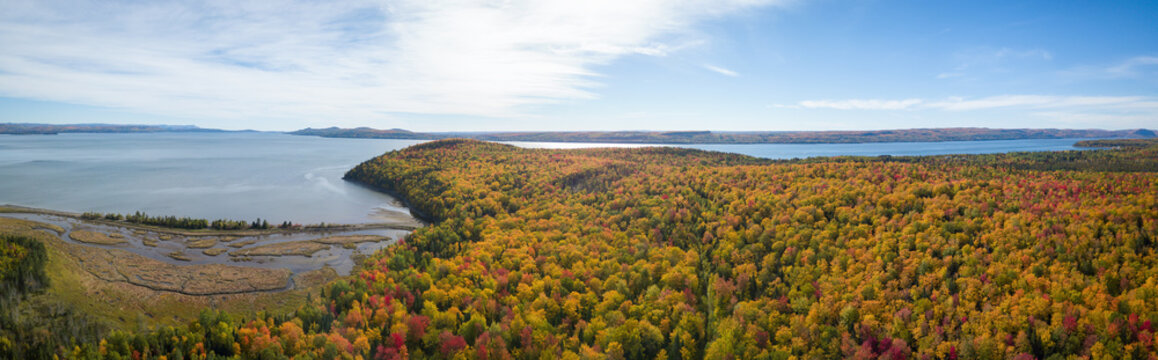 Aerial panoramic view of a beautiful Canadian Landscape during fall color season. Taken near Pointe-à-la-Croix, Quebec, Canada.