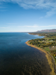 Aerial view of the Atlantic Ocean Coast during a sunny morning. Taken near Gesgapegiag, Quebec, Canada.