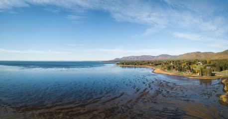 Aerial panoramic view of the Atlantic Ocean Coast during a sunny morning. Taken near Gesgapegiag, Quebec, Canada.