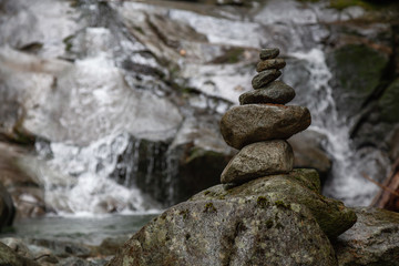 Fototapeta na wymiar Stack of Rocks near a waterfall. Taken in Mt Fromme, North Vancouver, British Columbia, Canada.