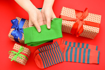 Colorful collection of cotton socks as a gift in woman hands.