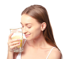 Beautiful woman a glass of water with lemon in hand health beauty on white background isolation