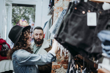 Woman buying clothes at the fashion store with boyfriend