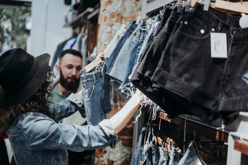 Woman buying clothes at the fashion store with boyfriend