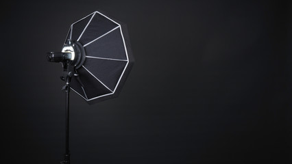 Professional photo studio soft box and flash on the tripod for stillphoto or video production which...