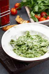 Spinach Green Ravioli with Parmesan Cheese. Healthy Italian Food. Vegetarian Tortellini on White Plate Side Close-up View for Menu