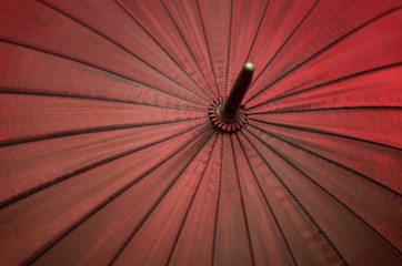 Abstract red color umbrella background, diagonal elements and centre.
