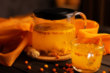 Sea buckthorn tea on a wooden background