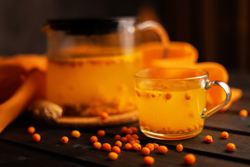 Sea buckthorn tea on a wooden background