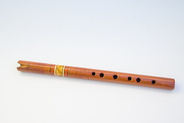 Old Quena of Peru (traditional flute of the Andes), with 37 notes and three octaves, 37 cm long. It consists of a tube with a simple notch, has six front holes, one back. Isolated on white background.