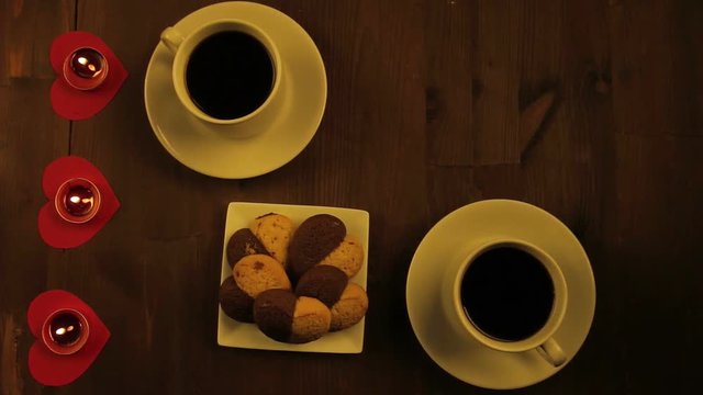 Two cups of coffee and candles on the table in a cafe