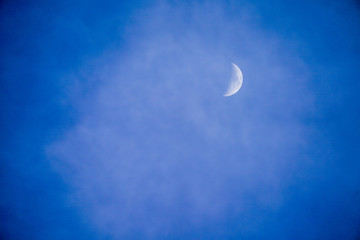 Obraz na płótnie Canvas Clearly beautiful blue sky with white half moon.