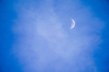 Obraz na płótnie Canvas Clearly beautiful blue sky with white half moon.