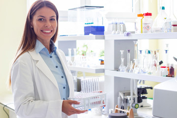 Girl in laboratory with tubes on her hand